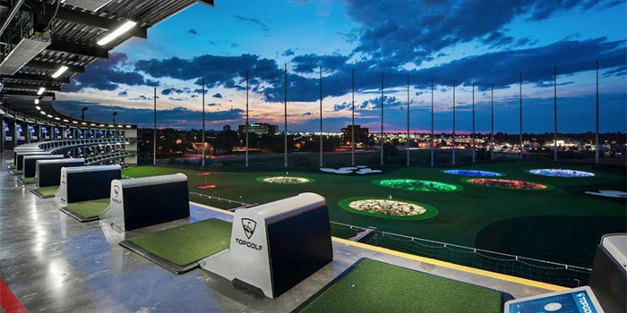Topgolf interior showing driving range